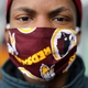 JoJo Houston wears a Washington Redskins face mask while helping Martha’s Table distribute hundreds of free hot meals donated by the Clyde’s Restaurant Group to people in need during the novel coronavirus pandemic, which has forced many people out of work and unable to reach healthy food, April 01, 2020 in Washington, DC.